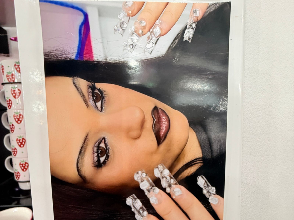 A photo of of a photo of singer Rosalia in her Euphoria makeup look hanging inside the Euphoria season 3 makeup trailer.